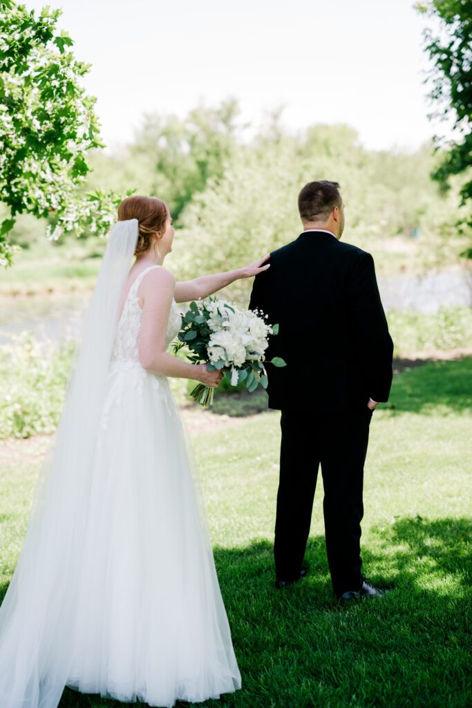 Bride and groom summer first look on the grounds at Fishermen's Inn.