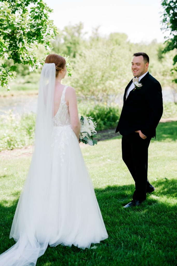 Bride and groom summer first look on the grounds at Fishermen's Inn.