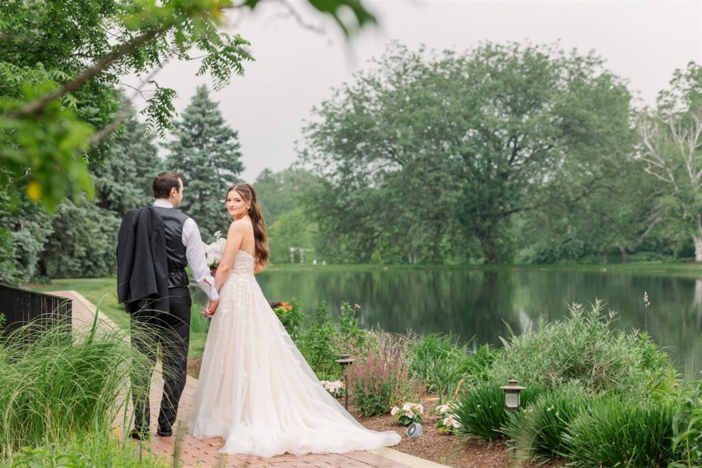 The bride and groom walk through the gardens at Fishermen's Inn.