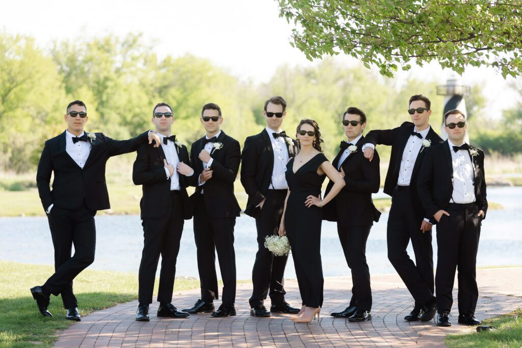 Groom's wedding party portrait at Fishermen’s Inn with black tuxedos and bow ties