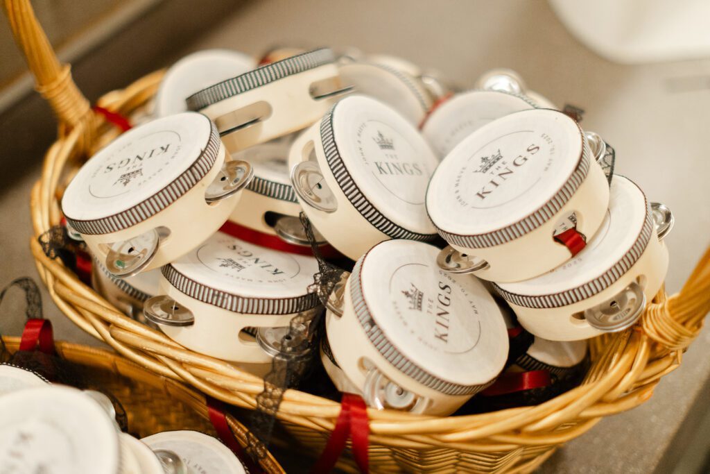 Custom mini tambourine with 'The Kings' branding in a basket