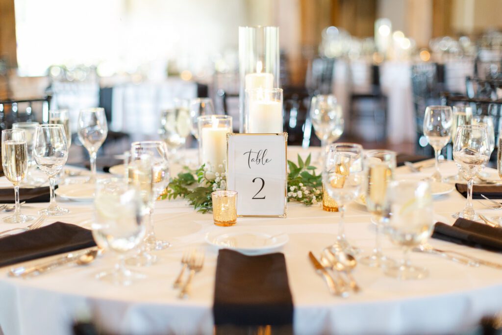 Elegant dining table with candles and greenery