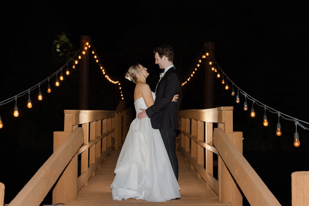 Bride and groom nighttime portrait on the bridge at Fishermen’s Inn