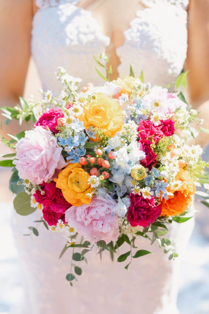 colorful spring bridal bouquet with peonies and ranunculus