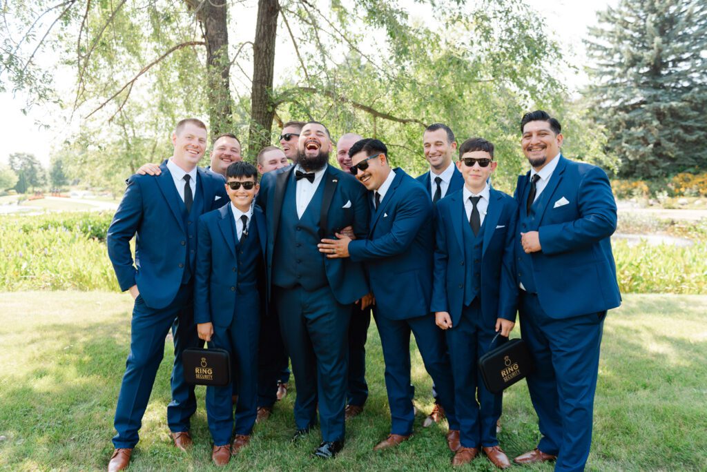 Ricky and his groomsmen posing together during the wedding day at Fishermen’s Inn