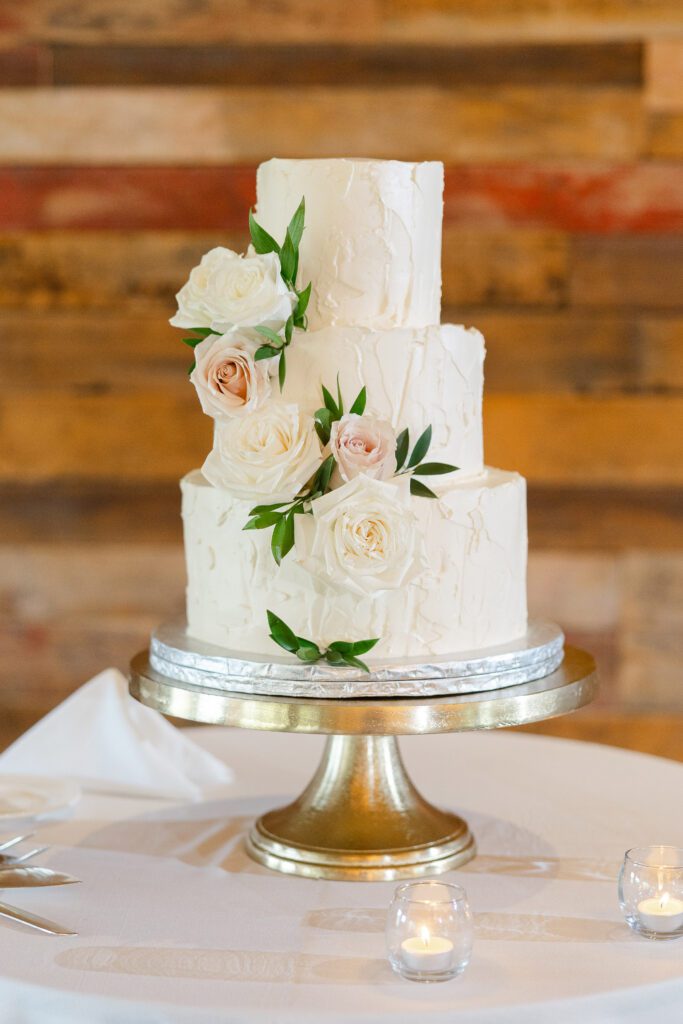 Classic white wedding cake decorated with greenery at Fishermen’s Inn
