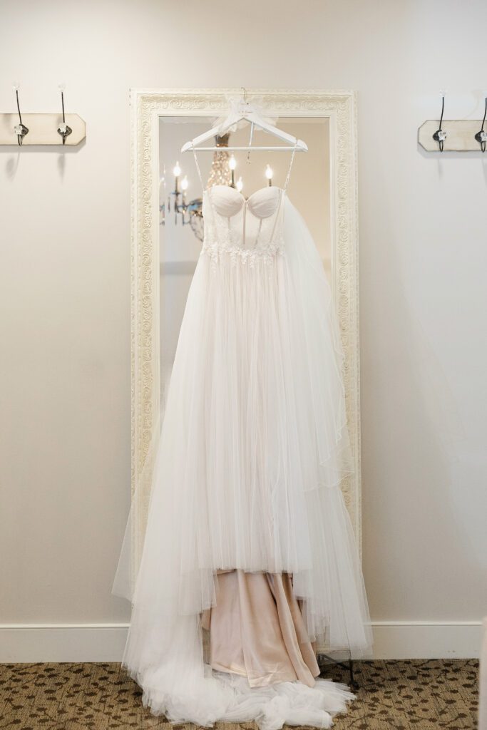 Tina’s white wedding dress hangs in the bridal suite at Fishermen’s Inn.